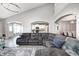 Bright living room featuring vaulted ceilings, hardwood floors, a large sectional couch and easy access to the kitchen at 5524 Goodwin St, Indianapolis, IN 46234