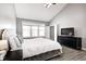 Well-lit main bedroom with a large bed, two bedside tables and dresser with TV at 5524 Goodwin St, Indianapolis, IN 46234