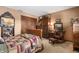 Bedroom with vintage furniture, a quilt-covered bed, and a cozy rocking chair at 5529 W 29Th Pl, Indianapolis, IN 46224