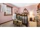 Charming bedroom featuring pink walls, antique furniture and natural light at 5529 W 29Th Pl, Indianapolis, IN 46224