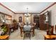 Formal dining room features a wooden table with seating for six, complemented by elegant decor and ample natural light at 5529 W 29Th Pl, Indianapolis, IN 46224