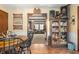 Charming dining area featuring hardwood floors, wood table, and a doorway to the cozy living room at 5529 W 29Th Pl, Indianapolis, IN 46224