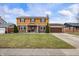 Traditional two-story home boasts brick and siding, a well-kept lawn, and a paved driveway leading to an attached garage at 5529 W 29Th Pl, Indianapolis, IN 46224