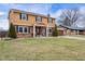 Charming two-story home featuring a brick and siding exterior, complemented by a well-manicured lawn and mature landscaping at 5529 W 29Th Pl, Indianapolis, IN 46224