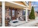 Inviting front porch features brick accents, decorative columns, and charming decor, creating a welcoming entrance to the home at 5529 W 29Th Pl, Indianapolis, IN 46224