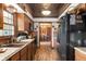 Galley kitchen featuring modern appliances, wooden cabinetry, and a unique decorative ceiling, blending style and functionality at 5529 W 29Th Pl, Indianapolis, IN 46224