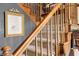 Beautiful staircase with wooden banister and carpeted steps leading to the upper level at 5529 W 29Th Pl, Indianapolis, IN 46224