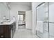 Bathroom boasts a shower, white countertops and dark cabinets with a view to the bedroom at 568 Harstad Blvd, Westfield, IN 46074