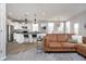 Bright living room with kitchen access and stylish modern finishes, including stainless appliances at 568 Harstad Blvd, Westfield, IN 46074