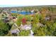 Scenic aerial view of a neighborhood near a lake surrounded by vibrant fall foliage at 5704 Springhollow Ct, Avon, IN 46123