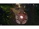 Aerial view of a backyard fire pit with lounge seating and adjacent upper deck with ambient string lights at 5704 Springhollow Ct, Avon, IN 46123