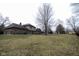 Expansive backyard featuring a well-maintained lawn and a classic brick house at 5704 Springhollow Ct, Avon, IN 46123