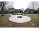 Backyard view of a two-story home, showing the firepit and deck area in a neutral-toned setting at 5704 Springhollow Ct, Avon, IN 46123