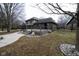 A two story home with a newly constructed deck and firepit area surrounded by landscaping at 5704 Springhollow Ct, Avon, IN 46123