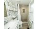 Stylish bathroom with updated vanity, shower and floors plus modern fixtures and grey floral wallpaper at 5704 Springhollow Ct, Avon, IN 46123