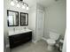 Bathroom with a double vanity, grey tile, and a separate toilet with overhead lighting at 5704 Springhollow Ct, Avon, IN 46123