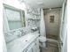 Bright bathroom features sleek vanity with modern fixtures, stand-up shower, and neutral floral wallpaper at 5704 Springhollow Ct, Avon, IN 46123
