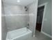 Bathroom features a white tub, tiled shower, and neutral walls, offering a serene atmosphere at 5704 Springhollow Ct, Avon, IN 46123