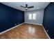 Spacious bedroom featuring hardwood floors, ceiling fan and dual-tone paint, with window to outside at 5704 Springhollow Ct, Avon, IN 46123