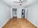 Bright bedroom featuring hardwood floors, ceiling fan, and closet for storage, with a doorway at 5704 Springhollow Ct, Avon, IN 46123