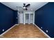 Spacious bedroom with wood floors, ceiling fan, and closet with curtains for extra storage at 5704 Springhollow Ct, Avon, IN 46123