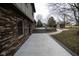 The side of brick home reveals an expansive patio and upper deck overlooking the landscaped backyard at 5704 Springhollow Ct, Avon, IN 46123