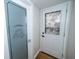 Hallway with Laundry room and stone-windowed door at 5704 Springhollow Ct, Avon, IN 46123