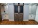 Rustic barn doors flanked by built in cabinets at 5704 Springhollow Ct, Avon, IN 46123