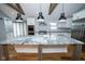 Modern kitchen featuring white cabinetry, stainless steel appliances, and a large marble countertop island at 5704 Springhollow Ct, Avon, IN 46123