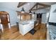 Large kitchen island with granite countertop, sink, dishwasher, and microwave at 5704 Springhollow Ct, Avon, IN 46123
