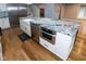 Close up of kitchen island featuring a granite countertop, sink, dishwasher, and microwave at 5704 Springhollow Ct, Avon, IN 46123