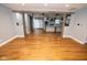 Open-concept living space with hardwood floors, rustic beams, and a seamless transition to the kitchen at 5704 Springhollow Ct, Avon, IN 46123