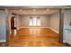 Open layout living space with hardwood floors, rustic beams, and a view of the front door at 5704 Springhollow Ct, Avon, IN 46123