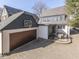 View of the home's backyard with a basketball hoop above the garage, patio, and dining area at 6009 N Washington Blvd, Indianapolis, IN 46220