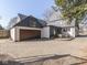 Exterior view of home with a basketball hoop over the garage and a patio area with a table and chairs at 6009 N Washington Blvd, Indianapolis, IN 46220