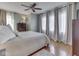 Spacious bedroom featuring a ceiling fan, hardwood floors, large windows, and neutral-toned decor at 6009 N Washington Blvd, Indianapolis, IN 46220