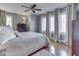 Spacious bedroom featuring a ceiling fan, hardwood floors, large windows, and neutral-toned decor at 6009 N Washington Blvd, Indianapolis, IN 46220