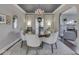 Dining room features elegant chandelier, neutral color palette, and transition to a comfortable living area at 6009 N Washington Blvd, Indianapolis, IN 46220