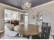 Dining room boasts chandelier, seamless transition to kitchen, spacious layout, and neutral decor at 6009 N Washington Blvd, Indianapolis, IN 46220