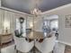 Dining room with a dark blue ceiling, a chandelier, curtains and a seamless transition to a living area at 6009 N Washington Blvd, Indianapolis, IN 46220