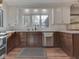 Bright kitchen with stainless appliances, dark cabinets, and hardwood floors at 6009 N Washington Blvd, Indianapolis, IN 46220