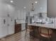 Eat-in kitchen with white cabinets, stainless appliances, and counter seating at 6009 N Washington Blvd, Indianapolis, IN 46220