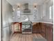 Modern kitchen with stainless appliances, white tile backsplash, and a stainless range hood at 6009 N Washington Blvd, Indianapolis, IN 46220