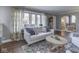 Cozy living room featuring a sofa, decorative pillows, stained glass windows and a round coffee table at 6009 N Washington Blvd, Indianapolis, IN 46220