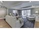 Bright living room featuring hardwood floors, neutral paint, and large windows at 6009 N Washington Blvd, Indianapolis, IN 46220