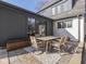 The home has a cozy outdoor patio area with an outdoor dining set and sliding doors to the home's interior at 6009 N Washington Blvd, Indianapolis, IN 46220