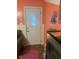 Hallway leading to outside with white door and wood flooring at 620 W Madison St, Alexandria, IN 46001