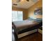 The bedroom features a large window, hardwood floors, and modern decor at 6526 Jade Stream Ct # 309, Indianapolis, IN 46237