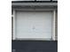 Single-car garage with a white panel door, providing secure parking and storage space at 6526 Jade Stream Ct # 309, Indianapolis, IN 46237
