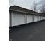 Row of white garages with a blacktop drive, offering ample parking for residents at 6526 Jade Stream Ct # 309, Indianapolis, IN 46237